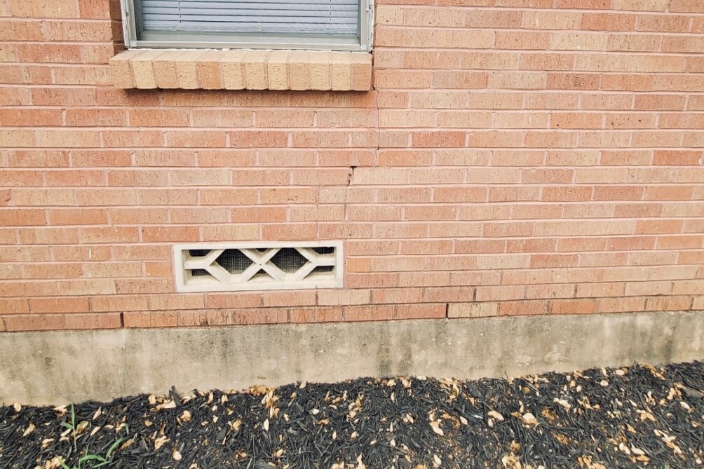 photo of the side of a house in need of foundation maintenance